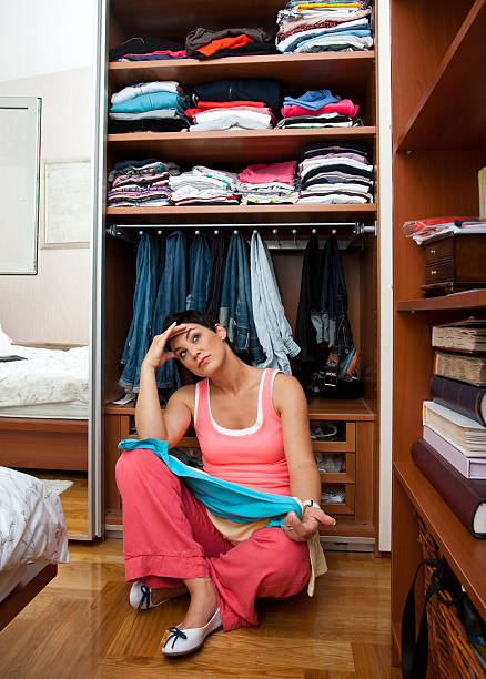 Choosing clothes a bad wardrobe day  stock photo