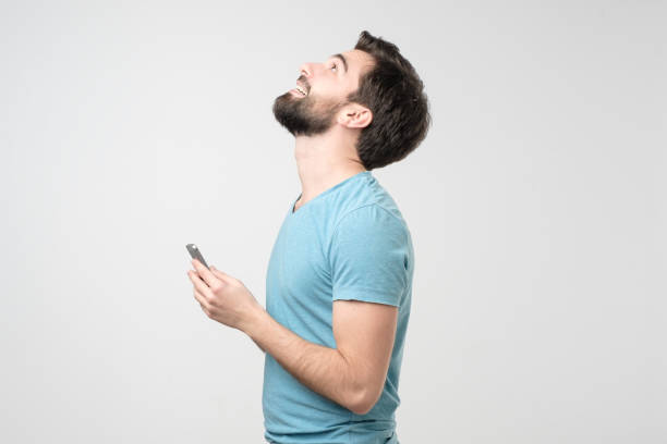 istock Young hispanic man speaking on the phone and smiling while looking up 1211039272