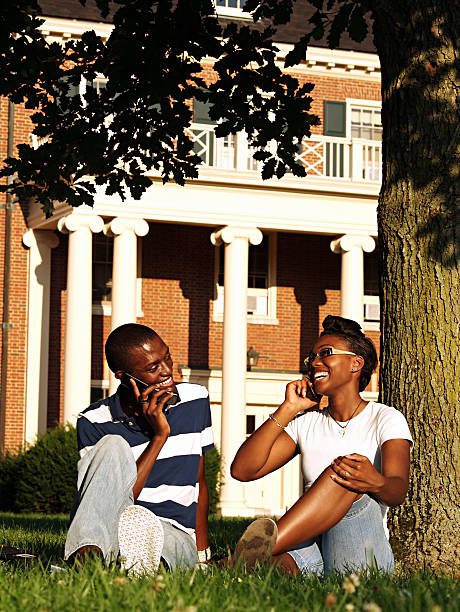 Young Adults using Cell Phones two young attractive adults using their cell phones. oxford ohio photos stock pictures, royalty-free photos & images