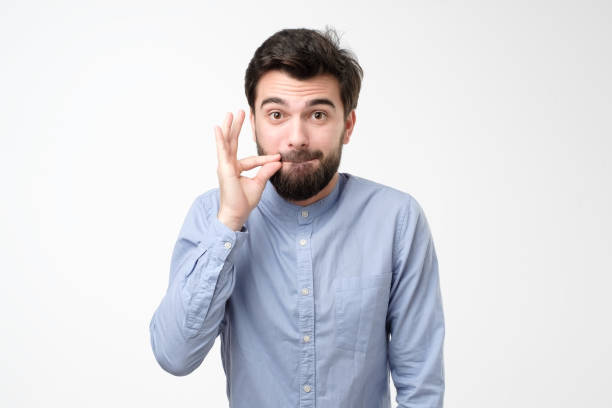 istock Bad teeth concept. man in glasses, making gesture with hand, zipping lips 1211040471