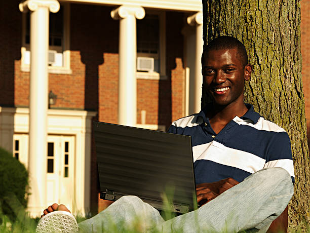 College Student on a Laptop a black college student using his laptop on campus. oxford ohio photos stock pictures, royalty-free photos & images