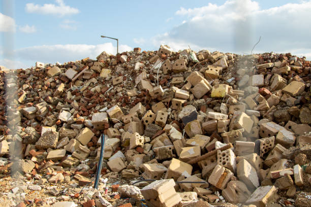 istock stones and other material on a mound after demoplition work on a house, blue sky 1211042027