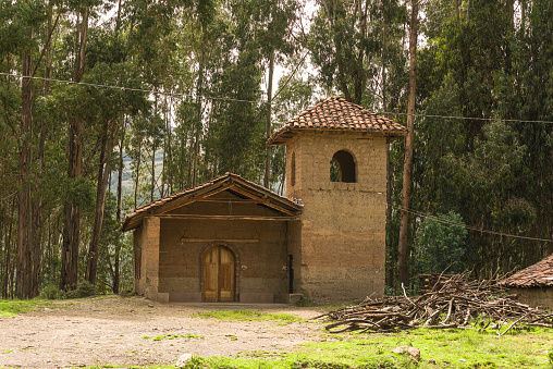 Exterior of a rural church made with clay bricks surroanded by Eucalyptus trees at a rural village in Conchucos Valley in Ancash Region, Peru