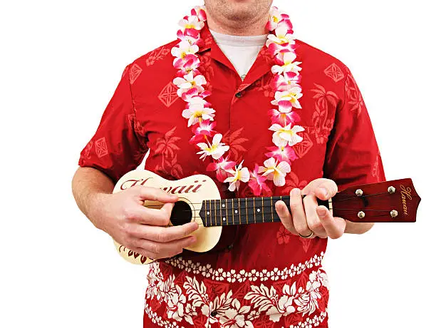 a man wearing a red Hawaiian shirt and lei playing the Ukulele isolated on white.