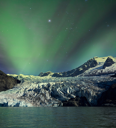 Mendenhall Glacier in Southeast Alaska with an aurora borealis sky.