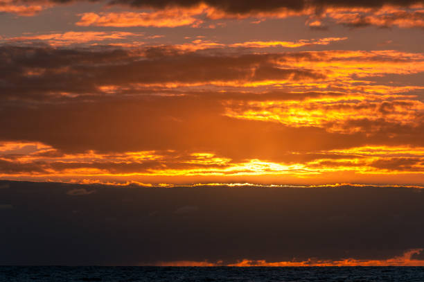 istock Ocean sunrise scene with waves and bright orange sky 1211045544