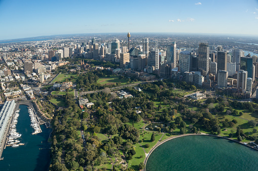 Aerial view of Sydney Royal Botanic Garden public garden and office skyscrapers of Sydney Central Business district. Modern urban aerial cityscape of green public places