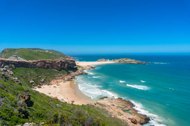 istock Summer seaside landscape with sandy beach and grassy hills 1211046120