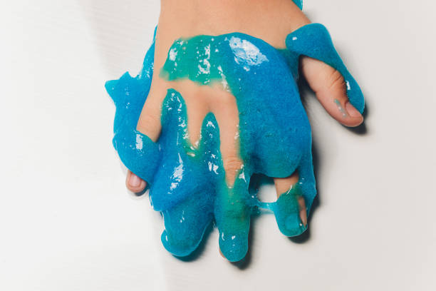 istock Kid Playing Hand Made Toy Called Slime Alien drool Shell mussel. 1211046194