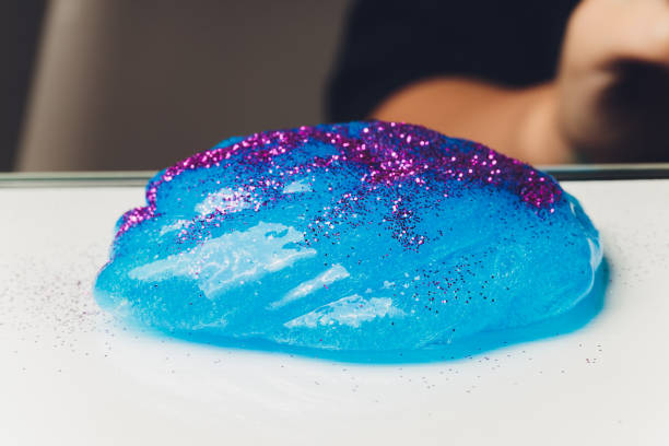 istock Kid Playing Hand Made Toy Called Slime Alien drool Shell mussel. 1211046197