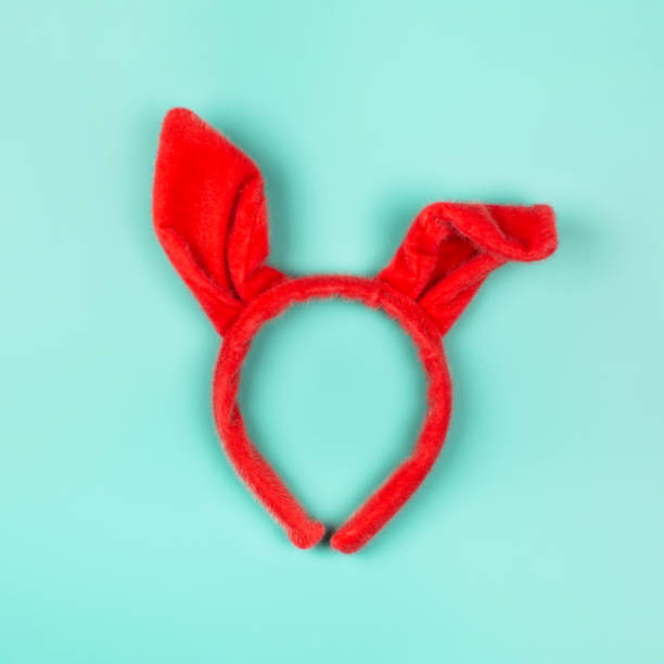 istock Red headband with bunny ears on blue pastel background. 1211046334
