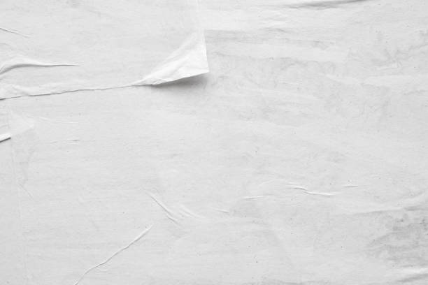 istock Blank white crumpled and creased paper poster texture background 1211046363