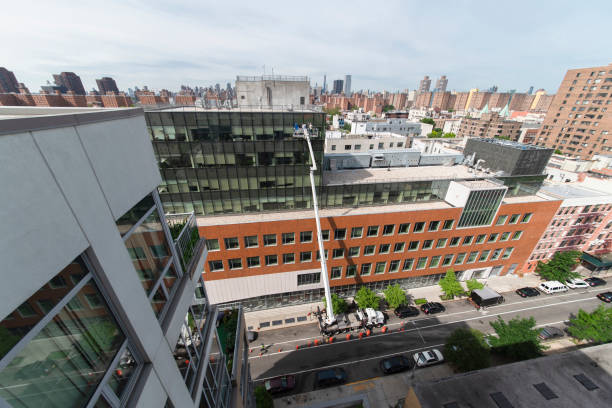 istock High-altitude work using the lifting platform in Harlem, New York City. High-angle view. 1211046945