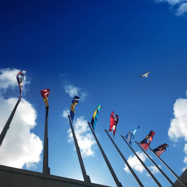 istock Close up group of colorful various countries flags at flagpoles 1211049245