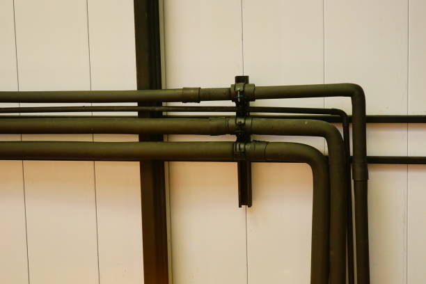 istock Pipes under the ceiling with industrial wiring conduits 1211054055