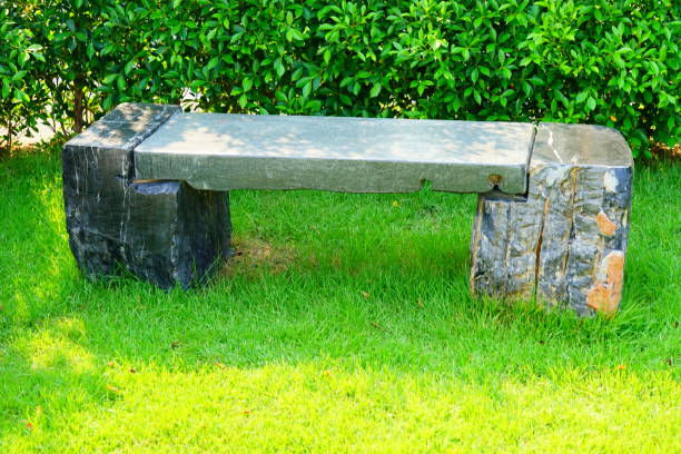 istock Stone Bench in green garden 1211054208