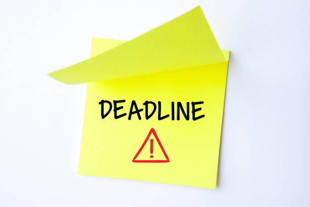 Yellow Sticky Note With Deadline And Red Push Pin On White Background