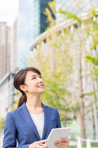 istock asian woman who see a tablet computer 1211055085