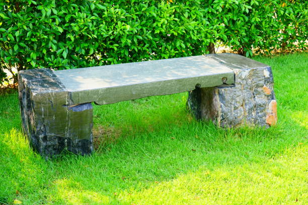 istock Stone Bench in green garden 1211055114
