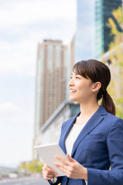 istock asian woman who see a tablet computer 1211055119