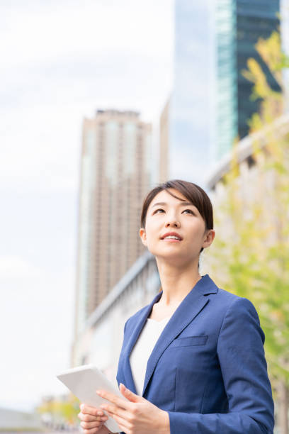 istock asian woman who see a tablet computer 1211055133