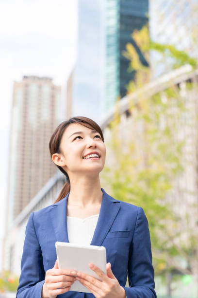 istock asian woman who see a tablet computer 1211055174