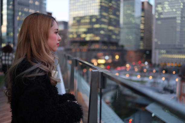 istock Beautiful young woman enjoying twilight view 1211059899