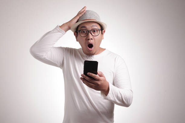 istock Young Man Texting Reading Chatting on His Phone Surprised Gesture 1211064895