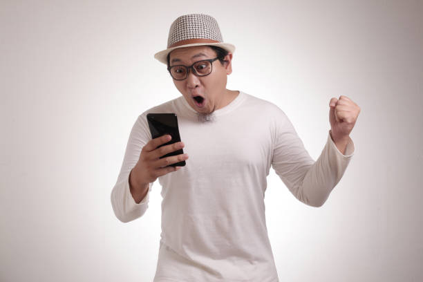 istock Young Man Texting Reading Chatting on His Phone, Smiling Happy 1211064952