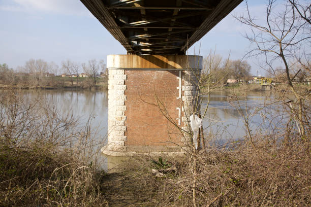 istock Pylon of a railway bridge made of bricks crossing over a river 1211066897