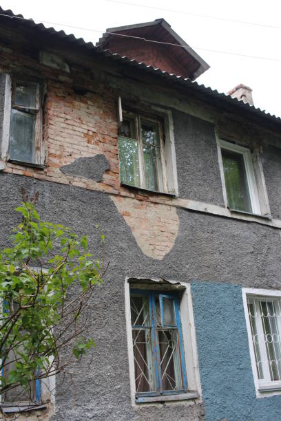 istock old apartment building with a destroyed facade in the Windows 1211068657