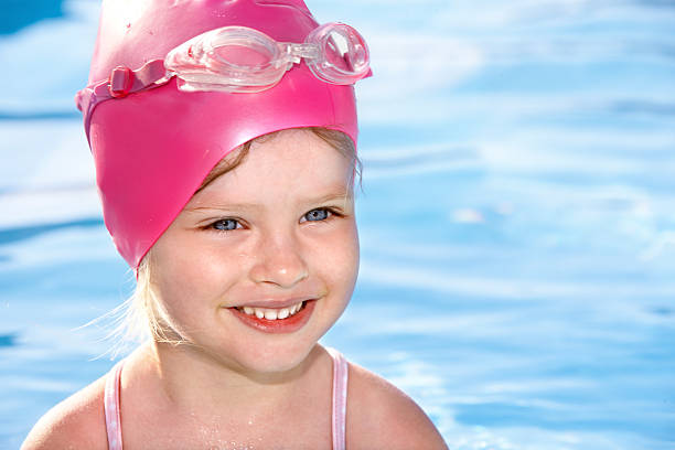 baby is sitting in a bubble bath in the garden on hot summer day. outdoor water treatments.