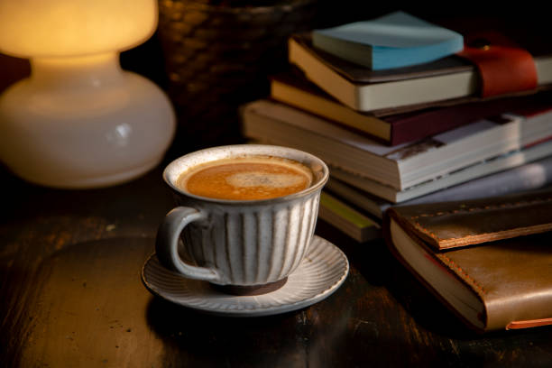 istock coffee break: books, notebook and coffee on wooden table 1211075392