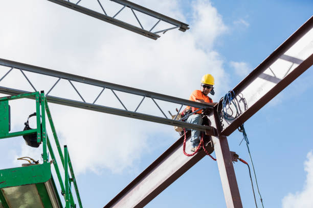 istock Ironworker at construction site installing roof joist 1211076132