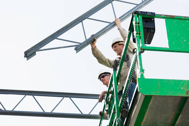 istock Steel workers installing roof trusses 1211076803