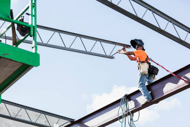 istock Ironworker at construction site installing roof joist 1211076806