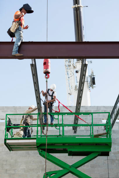 istock Crew installing roof joists at construction site 1211076861