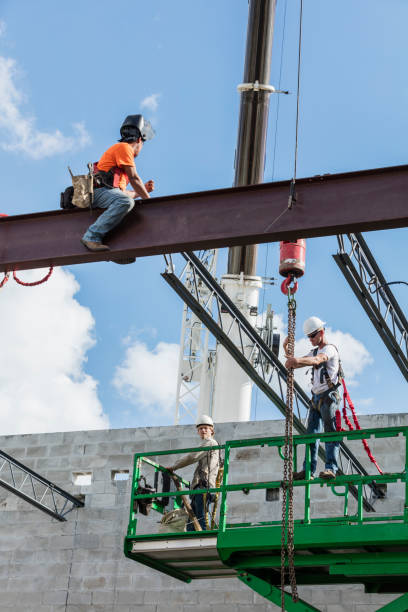 istock Crew installing roof joists at construction site 1211076863