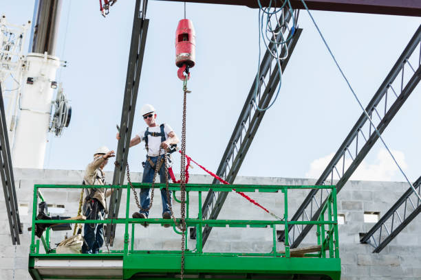 istock Steel workers installing roof trusses 1211076882