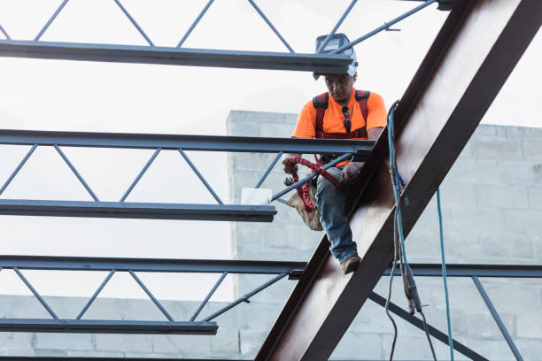 istock Ironworker at construction site installing roof joist 1211077008