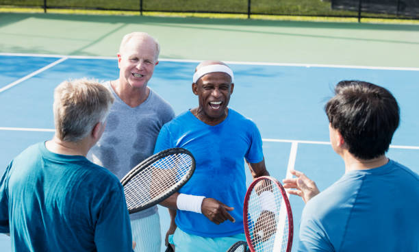 istock Men playing tennis, conversing at the net 1211078587