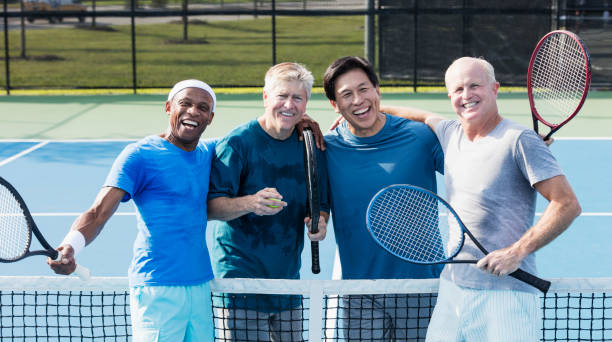 istock Men having fun playing tennis 1211078681