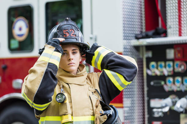 istock Female firefighter in fire protection suit 1211079699