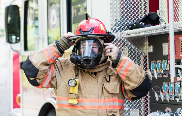 istock Firefighter in fire protection suit and respirator mask 1211079700