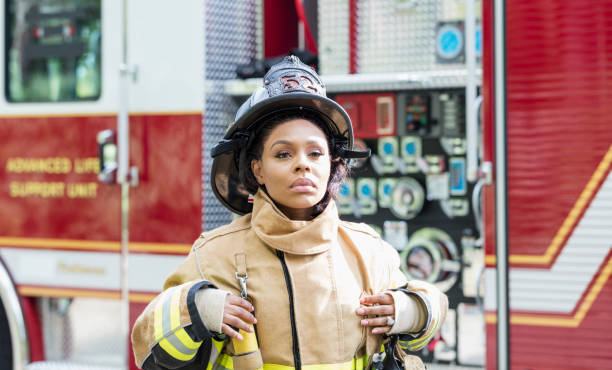 istock Female firefighter in fire protection suit 1211079761