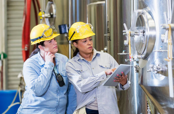 istock Two women working in factory, with digital tablet 1211080409