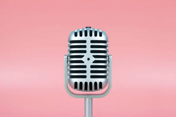 Photo of Retro microphone with copy space on pink background