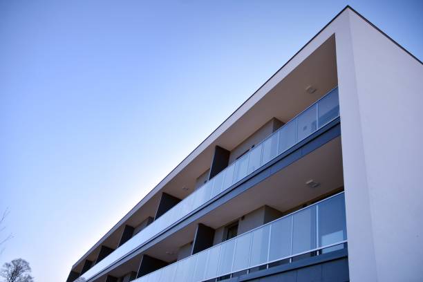 istock Modern multi story building being lit by the setting sun at afternoon. 1211089206
