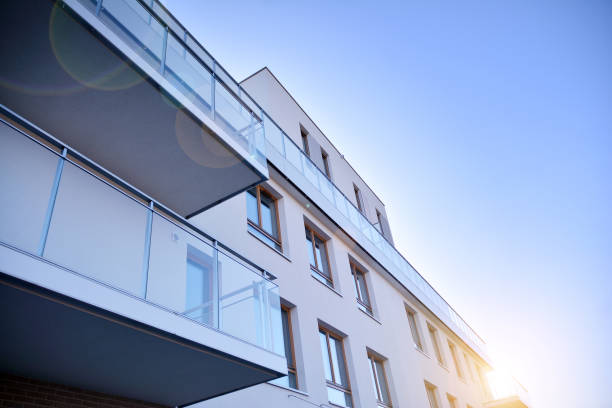 istock Modern multi story building being lit by the setting sun at afternoon. 1211089825
