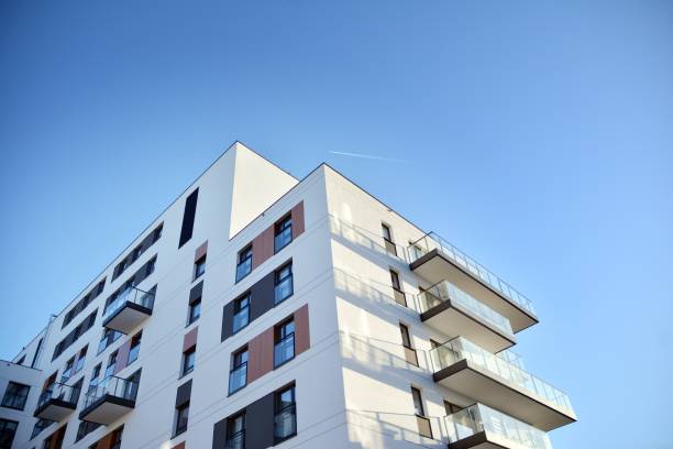 istock Modern multi story building being lit by the setting sun at afternoon. 1211089968